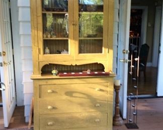 Mustard color painted step back cabinet