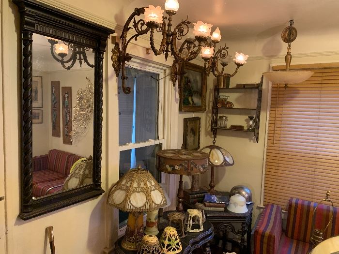 Turn of the century elegant victorian wall sconces with flame and flower shades out of a prominent downtown building. Antique mirror, lamps, tables