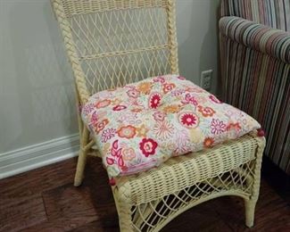 Yellow wicker chair with floral cushion