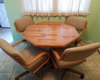 Really nice table with 1 leaf and 4 rolling chairs. Looks brand new