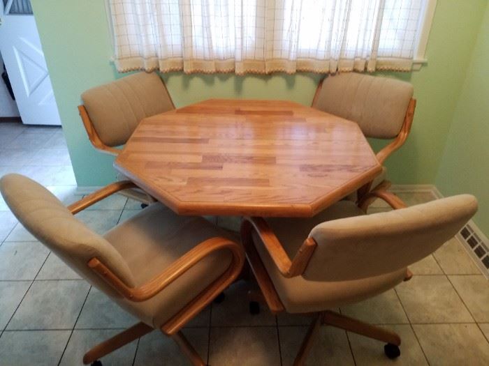 Really nice table with 1 leaf and 4 rolling chairs. Looks brand new
