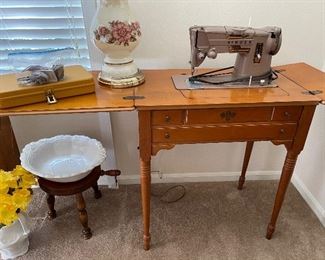 Vintage sewing machine in cabinet. 