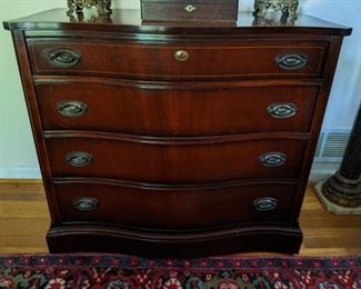 Pristine 1940's Bassett mahogany serpentine-front four drawer chest, with string inlay and original brass pulls.
