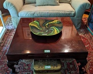 Baker mahogany cocktail table, w/pull-out tray, vintage English brass trivet and Donghia sofa.