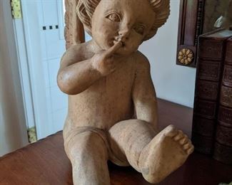 Hand-carved wooden angel, with a secret to tell. 