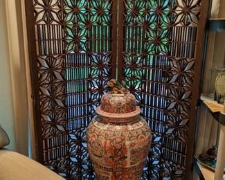 4-panel wooden Moravian screen, behind 33" tall Asian Happy Family Porcelain ginger jar, with foo dog finial, on wooden stand.