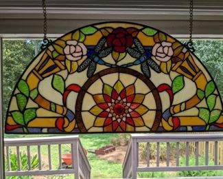 Another lovely stained glass window, in a metal frame, with floral cornucopias and dragonflies.