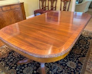 Widdicomb Georgian-style banded carved mahogany dining table $2,000 (originally $10,400)                                            30"h x 46.5"w x 77" long                                                        extends to 131" with three 18" leaves -  wear spot