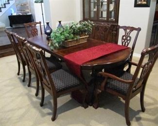 Dining table with eight chairs, pads and leaves