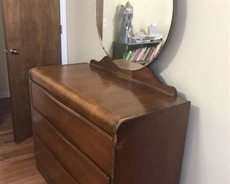 Art Deco waterfall dresser with mirror excellent condition goes with bedroom set. (44" L x 20" D) with 30" round mirror