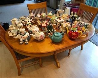 Dining table with one leaf and six chairs; large collection of teapots.