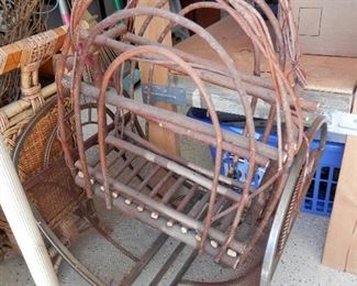 Bent willow piece sitting on wrought iron and steel wood cradle