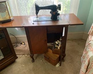 Antique sewing machine with cabinets.