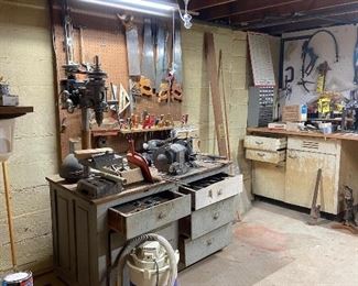 Basement with many items including tools, bar items, lots of antique items and collectibles, cast iron bathtub loveseat