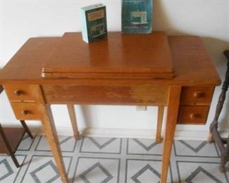 Wooden sewing cabinet with Singer machine