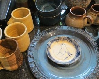 LOTS OF POTTERY IN THE KITCHEN.