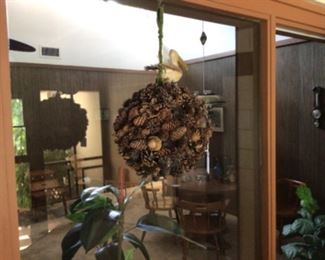 Hanging pine cone decor with pelican