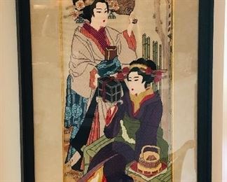 "Two Geisha"; cross-stitched and variations; one hand maiden stands behind in silver and maroon, holding a brown fan for her lady; in front, the seated bride admires a silver and black jewel box in her hands. Her kimono is in blues and violet tones and gold with scarlet; with an Obi in gold and green; signed LR in corner: "DP" in a woven tea basket that rests on the bamboo bench alongside the bride. The bench is on a woven tatami mat on the ground; Image 46.5" h x 27" w; frame 50.5" h x 35" w. $3,000 (Professional art appraisal in 2014 $20,000)