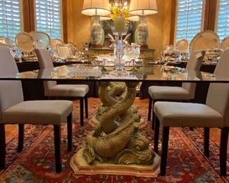 Gorgeous glass top dining room table with carved Koi fish pedestal base. 