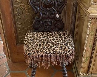 Primitive side chair with spindle legs and leopard print cushion