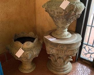 Cast iron footed urn with lion and cherub heads