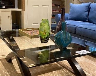 Glass top coffee table with arched wood base