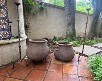 Terra cotta planters and large outdoor iron candlestands 