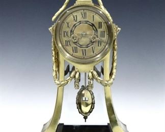 A turn of century Lenzkirch Neoclassical Bronze table clock.  8-day time and strike movement with Brass dial and Roman numerals, original pendulum, serial # 1 Million 783087.  Cast Brass case with urn finial, foliate swags, beveled lower glasses and short bracket feet. Polished case with minor wear, running when cataloged.  17 1/4" high.  ESTIMATE $1,000-1,500
