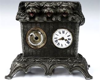 A late 19th century German Animated novelty clock by K. Mayer & Sohne.  30-hr key wind time only movement with porcelain dial and Roman numerals, stamped "Mayer" verso, and subsidiary thermometer.  Cast Iron "Basket" case features three dog figures with animated tongues peeking out of the top.  Old Silvered finish with some wear, dial hairlines, running when cataloged.  6" high.  ESTIMATE 300-400