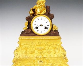 An early 19th century Empire Bronze mantel clock by Japy Freres.  8-day time and strike movement with a convex porcelain dial and Roman numerals with engine turned bezel silk thread suspension.  Bronze case with two color Brown/Gilded patina features an Allegorical figure of "Autumn" holding shocks of Wheat with an amphora at her feet, seated on a rocky outcropping, on a base with gilded Bronze facade with foliate scrolls and shaped Brass sides.  Displayed within a blown glass dome on an oval Ebonized molded wood base.  Well preserved finish with bright Gilding and slight wear, running when cataloged.  The clock is 13 1/2" high, dome and base are 18 x 9 x 17 1/2" high overall.  ESTIMATE $800-1,200