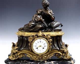 A late 19th century French Bronze and Marble mantle clock by "H P & Co".  8-day time and strike movement with visible escapement and two part porcelain dial with Roman numerals and engine turned bezel, serial # 15411.  Bronze and Marble case with a Guardian Angel with two children on a case with Verde Marble and Black Slate.  Minor edge damage, replaced feet, faint hairline in chapter ring, running when cataloged.  16 1/2" high.  ESTIMATE $1,000-1,500 
