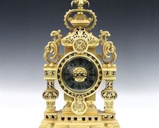 A late 19th century French Bronze table clock by Japy Freres.  8-day time and strike movement with cast Bronze dial and Silvered chapter ring with Roman numerals. dial with Roman numerals and engine turned bezel, serial # 11273.  Gilded Bronze case with a scrolled top and floral finial, squared reticulated columns with Gryphon finials, bats and Fleur-di-Lis detail on a stepped reticulated base with Lion feet.  Only slight wear, running when cataloged.  18 1/4" high.  ESTIMATE $1,000-1,500 