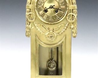 A turn of century Lenzkirch Neoclassical Brass table clock.  8-day time and strike movement with Brass dial and Roman numerals, original pendulum, serial # 1 Million 466779.  Cast Brass case with arched top, foliate swags, lower glass and molded base with pierced floral detail. Polished case with minor wear, running when cataloged.  16" high.  ESTIMATE $600-800