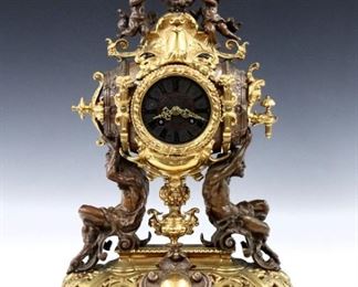 A turn of century Lenzkirch Bronze table clock with Bacchanalian motif.  14-day time and strike movement with Cast dial, Red enamel inlay and Roman numerals, filigree hands and original mask pendulum, serial #549522.  Bronze two tone case with putti on a keg, scroll work detail and satyr supports on a shaped filigree base with mask feet. Some surface wear, running when cataloged.  20" high.  ESTIMATE $3,000-4,000