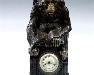A late 19th century Junghans Animated novelty clock.  30-hr key wind time only movement with Silvered dial and Arabic numerals, eyes and mouth move up and down as it ticks.  Cast Iron case with patinated Spelter Monkey facade with painted detail.  Some wear, running when cataloged, eyes and mouth need adjustment.  9 3/4" high.  ESTIMATE $300-400