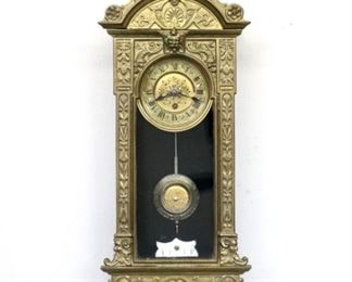 A 19th century Miniature Vienna Regulator wall clock by Rudolf Mayer.  3-day spring driven time only movement with a 3 1/8" two part engraved metal dial, Roman numerals and molded Brass bezel, serial #9150, with two tone pendulum.  Cast Bronze case features an arched crown with central finial over a single arched door and shaped drop, cast maker's label verso.  Minor wear, running when cataloged.  16 3/4" high overall.  ESTIMATE $800-1,200