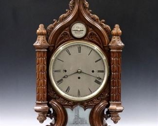 A turn of the century English Gothic Revival Bracket clock by "G. F. Younge, Sheffield".  8-day triple train chain driven fusee movement with quarter hour chiming on 8 Bells, and additional hour bell, having a circular Silvered dial with Roman numerals and engraved upper subsidiary dial for Chime/Not Chime with the maker's name.  Gothic Revival Oak case with molded central arch and carved foliate detail, carved finials and corner columns on a scrolled base with original presentation plaque which reads "Presented to, The Rev Stephen K Langston, M. A., By The Congregation of St. Georges Church, Sheffield...Sept. 1840".  Older cleaned finish with minor wear, replaced top finial, running when cataloged.  37 1/4" high overall.  ESTIMATE $3,000-4,000