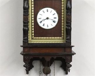 A late 19th century German Cuckoo clock with exposed oversize songbird at crown.  30 hour weight driven time and strike movement with porcelain dial and Roman numerals, painted songbird at crest.  Carved Black Forest Pine case with a galleried crown over a single door with turned pilasters, gilded liner and shaped drop with turned finials.  Original dark finish with Ebonized detail, wear and minor damage, restored songbird, running when cataloged.  Approx 24" high plus weight drop.  ESTIMATE $1,000-1,500
