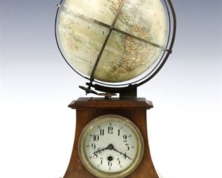A turn of the century French desk clock with globe.  30 hour time only German movement with balance wheel escapement, Silvered dial and Arabic numerals, also drives the 7" upper terrestrial globe with French titles within an equatorial horizon band numbered with the hours of day.  Mahogany lower case with a molded top and base, curved sides and scrolled apron.  Some wear and surface grunge, running and functioning when cataloged.  16 1/2" high overall.  ESTIMATE $800-1,200