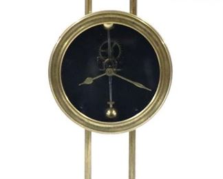 An early 20th century English gravity desk clock.  30 hour time only gravity powered movement with dumbbell pendulum.  Brass case with circular bezel, molded cornice and base, urn finials and ball feet.  Some wear, running when cataloged.  10 1/4" high.  ESTIMATE $200-300