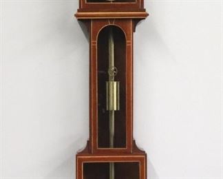 A late 20th century Laterndluhr type wall clock.  8-day weight driven time only movement with a flat porcelain dial and Roman numerals, cast Brass bezel.  Mahogany case with Maple stringing features a peaked pediment above a lift out upper door, narrow waist door and square lower, shaped drop.  Minor finish wear, running when cataloged.  37" high.  ESTIMATE $400-600