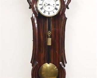 A 19th century Vienna Regulator wall clock by Carl Suchy & Son, Vienna.  8-day quarter hour Grand Sonnerie striking on two coiled gongs, two part porcelain dial with Roman numerals and molded Brass bezel, marked "C. Suchy et Sohne In Prag" on dial.  Mixed wood Serpentine case with grain painted finish, scrolled crest with filiate carving and shaped drop with turned finial.  Older finish with some wear, replaced lower finials, multiple hairlines in dial, running when cataloged.  47 3/4" high.  ESTIMATE $600-800