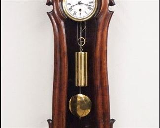 A 19th century Miniature Vienna Regulator wall clock.  8-day spring driven time only movement with a 3 1/4" two part porcelain dial, Roman numerals and molded Brass bezel and compensating R/A pendulum.  Serpentine case with Ebonized finish, shaped molded crown over a single shaped door and shaped drop with turned finial.  Minor wear, restored crest, running when cataloged.  15 1/4" high overall.  ESTIMATE $800-1,200