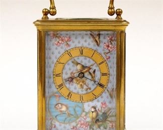 An early 20th century French carriage clock.  8-day time only movement with hand painted porcelain dial, Gold chapter ring and Roman numerals.  Brass case with swing handle, molded top and base, beveled glass inserts.  Minor wear, running when cataloged.  6 1/4" High overall.  ESTIMATE $400-600