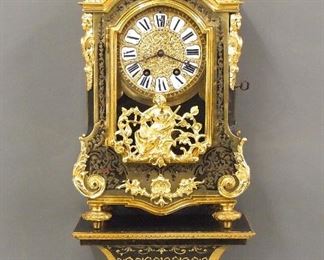 A late 19th century French Boulle Louis XV style bracket clock.  8-day time and strike movement with cast Bronze dial and porcelain markers with Roman numerals and engraved minutes with Apollo Mask pendulum.  Movement marked "G L F".   Black Boulle case with Brass Marquetry inlay and gilded Bronze mounts including floral and flame finials, caryatid corners, foliate scrolls, lower door medallion and turned feet.  Minor wear, some older repairs, hairlines and minor edge damage to dial markers, running when cataloged.  29 3/4" high.  EATIMATE $2,000-3,000