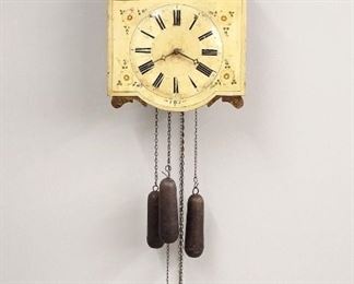 An early 19th century German Black Forest wall clock with "Bellringer" automaton.  30 hour time and strike movement with quarter hour strike on three bells, shaped painted wooden dial with Roman numerals and carved painted figures.  Original finish with wear, cracks and minor damage, replaced side access doors, running and functioning when cataloged.  48" high plus weight drop.  ESTIMATE $800-1,200