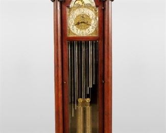A turn of the century Herschede Pattern No. 87 hall clock.  8-day weight driven two train movement with striking on nine tubular chimes, arched Brass dial with painted moon phases and engraved hemispheres, a Silvered chapter ring with Arabic numerals and subsidiary dials for seconds, Whittington/Westminster/Silent, Strike/Silent, engraved filigreed spandrels and dial center, serial #6530, damascened plates.  Mahogany Neoclassical style case with hand carved decoration features a molded pediment crown above an arched opening over a single long door with beveled glass panels flanked by full length turned columns on a stepped molded base with gadrooned feet.  Original finish with minor wear, running when cataloged.  97" high.  ESTIMATE $ 2,000-3,000