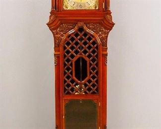 A Rare 4-train, 6 tune late 19th century Gothic Revival Period hall clock.  High quality 4-train movement, probably by Elliott with thick Brass plates and 6 turned posts, features a choice of 6 tunes, with quarter hour striking on a nest of 15 bells with 18 hammers or 5 coiled gongs, arched Brass dial with painted moon phases and engraved hemispheres, a Silvered chapter ring with Arabic numerals, Silvered seconds dial and lower date aperture, with subsidiary dials for Silent/Strike Hours/Full Strike, Music/Silent, Chime/Silent and Easter Hymn/Auld Langsyne/Jolly Young Waterman/Blue Bells Of Scotland/Home Sweet Home/The Harp That Once Thro'Taras Halls tune selector, retailed by "Bailey, Banks & Biddle, Philadelphia" with cast gilded spandrels.  Carved Mahogany Gothic Revival Period case, attributed to R. J. Horner, New York, features a molded arch with carved foliate detail over a molded crown and sharp Gothic arches on the frieze over and arched molded dial door with beveled glass flan