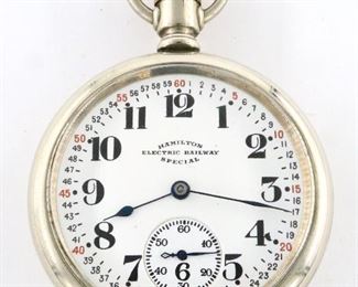 A Hamilton 956 Model "Electric Railway Special" pocket watch.  16 size, 17 j, Adj, DMK, Swing Out movement, SW, PS, Philadelphia "Silverode" OF, "Montgomery" Porcelain SSD with Arabic numerals marked "Hamilton, Electric Railway, Special", serial #1704860.  Minor wear, winds, sets and running when cataloged.  ESTIMATE $200-300