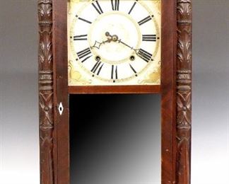 A 19th century Ephraim Downs shelf clock.  30-hour weight driven wooden time and strike movement with painted wooden dial and Roman numerals.  Mahogany case with a carved scrolled crest over a door with clear dial glass and mirrored lower flanked by carved foliate pilasters, carved paw feet.  Paper label 60% intact.  Original finish with some wear, minor damage, running when cataloged. 29 1/4" high.  ESTIMATE $300-400